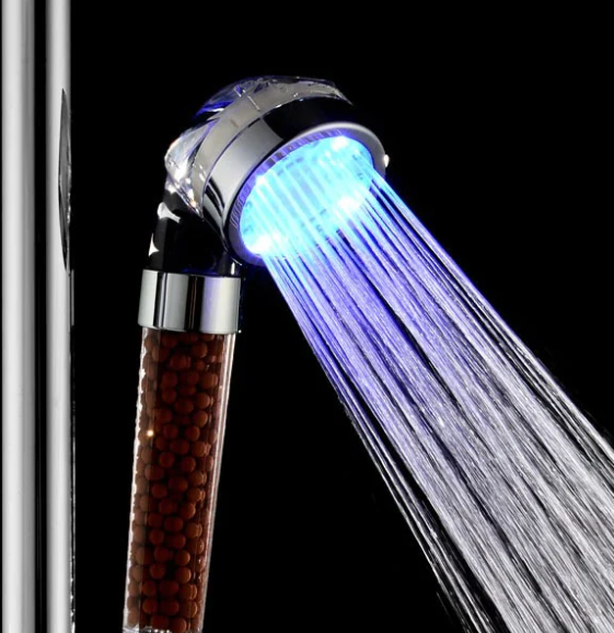 Mineral Stream LED shower head with water illuminated with blue light against a black background. 