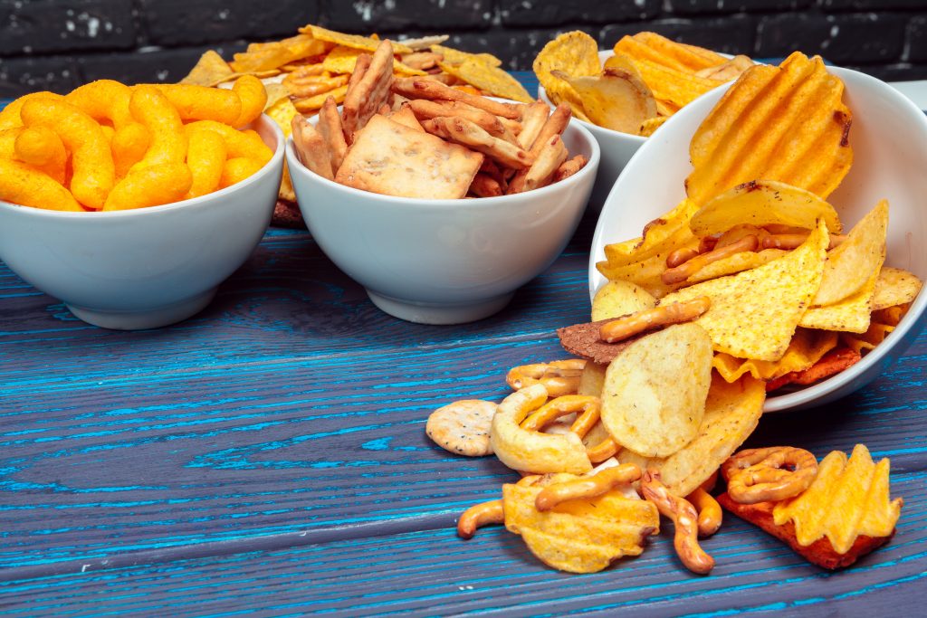 A number of fried snacks and foods high in sodium. Fries, chips, cheese puffs, and crackers that can cause bloating.