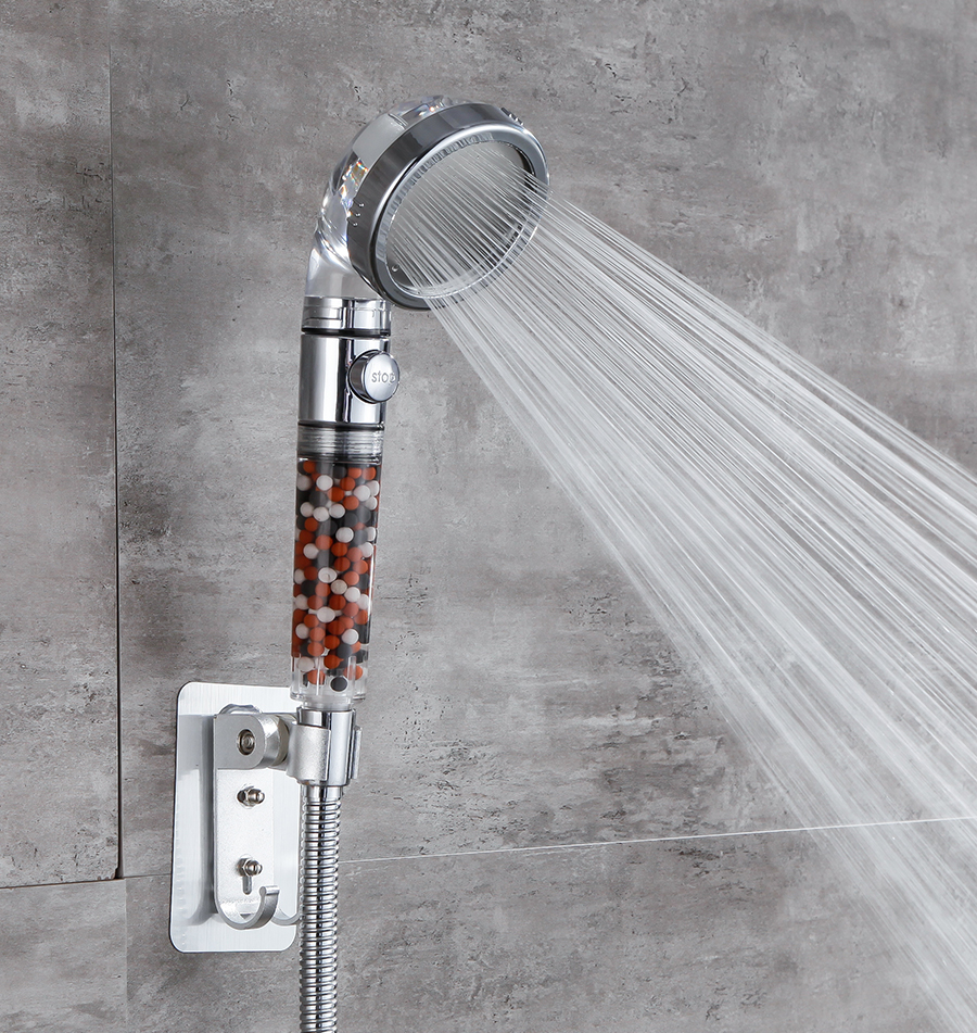 A StoneStream EcoPower shower head in rainfall mode in a grey walled bathroom. Bathroom decor ideas. 